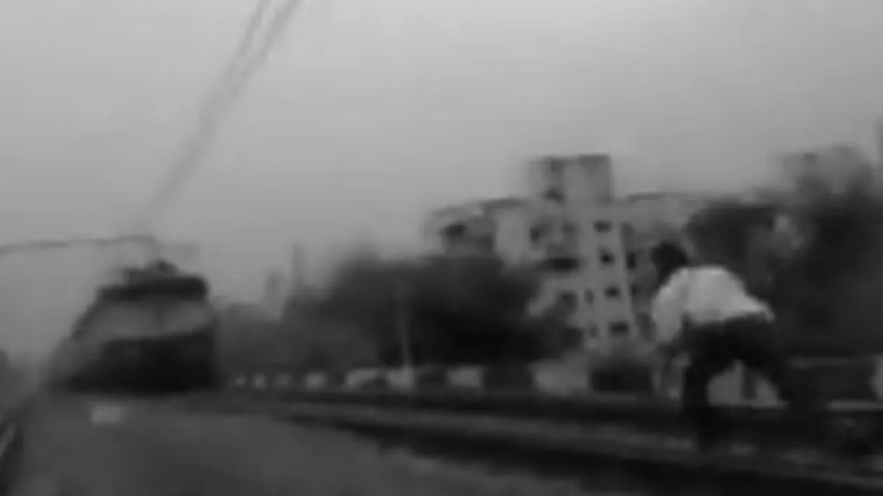 Șocant: Un indian își riscă viața aruncându-se în fața trenului pentru a-și impresiona prietenii! (VIDEO)