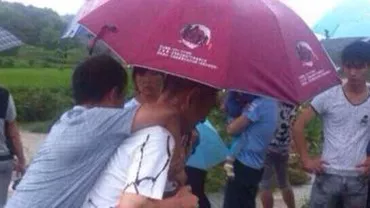Un oficial chinez ce a fost cărat în spate într-o zonă inundată a fost demis în urma unui scandal pe internet (FOTO)
