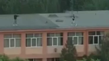 Argeș: Doi tineri au fost filmaţi jucându-se cu mingea pe acoperişul unei şcoli (VIDEO)